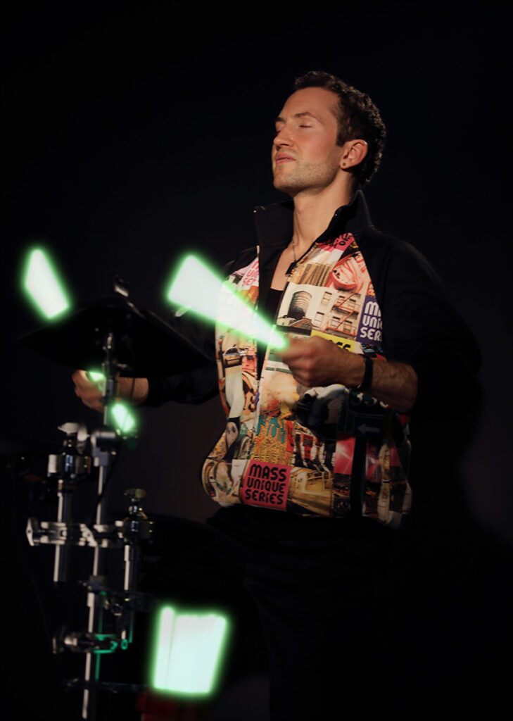 Neo M playing with laser drumsticks on visual drums